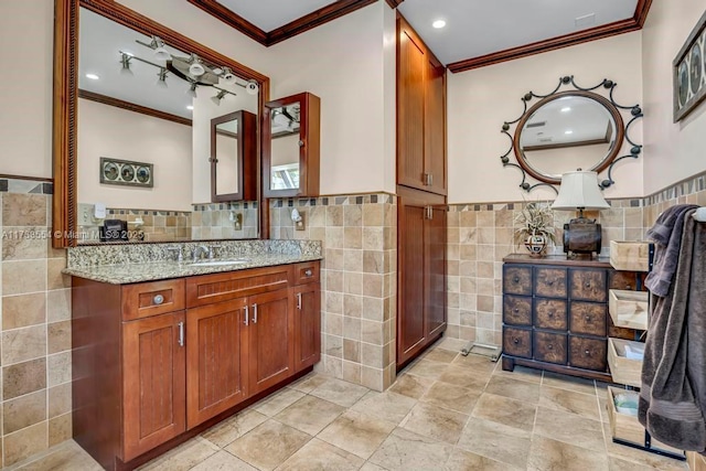 bathroom featuring tile walls, vanity, and crown molding