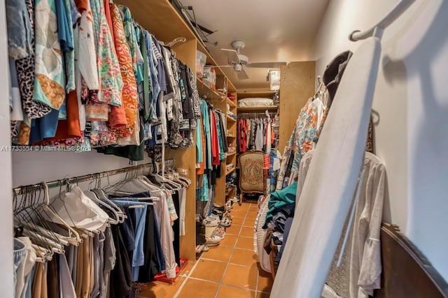 spacious closet with light tile patterned floors and ceiling fan