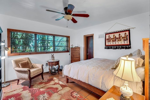 tiled bedroom featuring ceiling fan