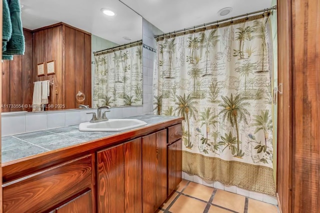 bathroom featuring vanity, shower / bathtub combination with curtain, and tile patterned flooring