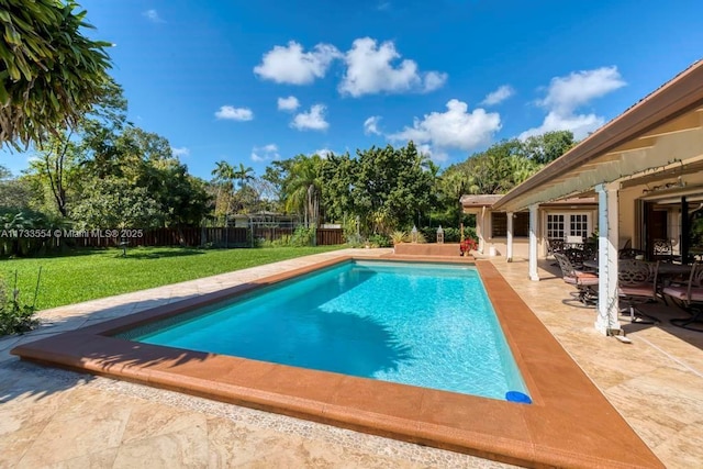 view of swimming pool featuring a yard and a patio area