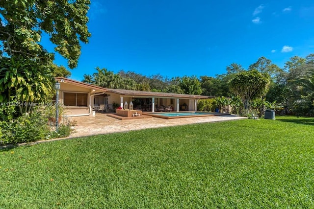 back of property featuring a patio and a lawn