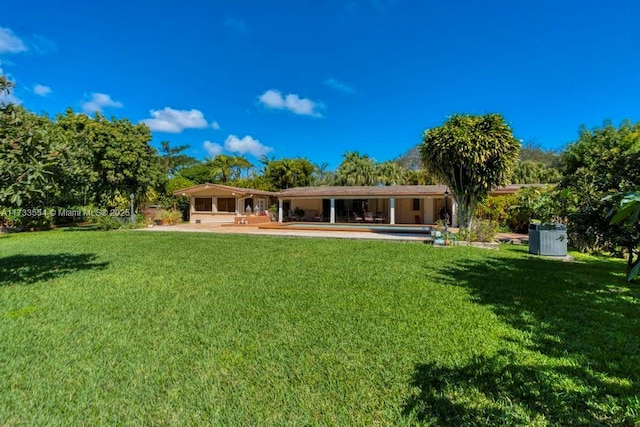 back of house featuring a yard and a patio area