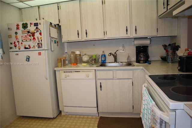 kitchen with backsplash, white appliances, sink, and light brown cabinets