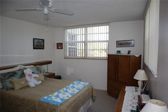 bedroom featuring ceiling fan, carpet floors, and a textured ceiling