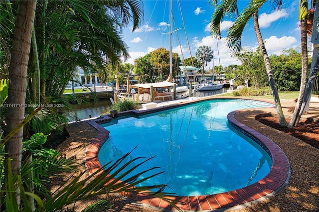 view of swimming pool with a water view