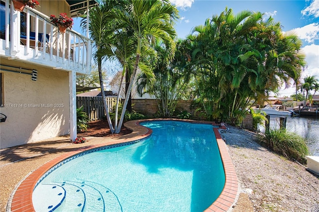 view of swimming pool with a water view