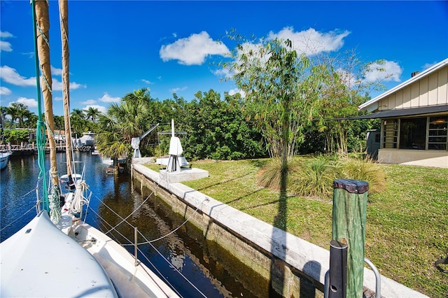 dock area featuring a water view and a yard