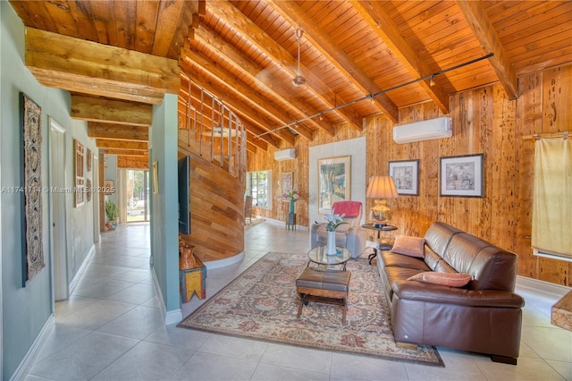 living room with a wall mounted air conditioner, wood walls, lofted ceiling with beams, light tile patterned floors, and wood ceiling