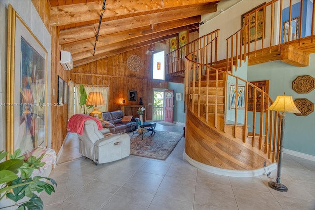 tiled living room with a wall mounted air conditioner, beam ceiling, a towering ceiling, and wood walls