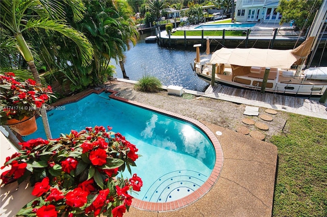 view of pool featuring a boat dock and a water view