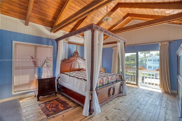 bedroom with wooden walls, vaulted ceiling with beams, access to outside, light hardwood / wood-style floors, and wooden ceiling