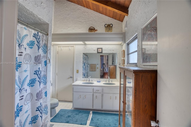 bathroom with toilet, vaulted ceiling with beams, wood ceiling, vanity, and tile patterned flooring