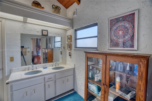 bathroom featuring lofted ceiling and vanity