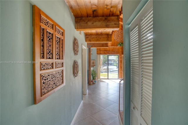 hall with wood ceiling, beam ceiling, and light tile patterned flooring