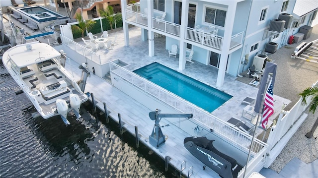 view of pool with central AC unit and a patio