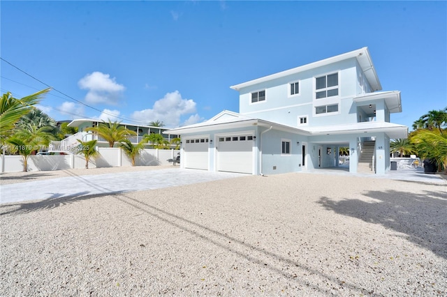 view of front of home with a carport and a garage