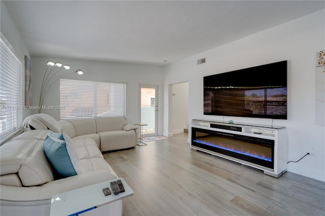 living room with a healthy amount of sunlight and light wood-type flooring