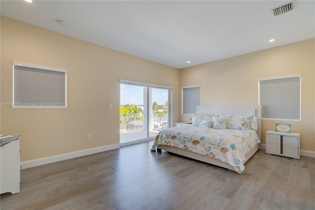 bedroom featuring light hardwood / wood-style floors and access to outside