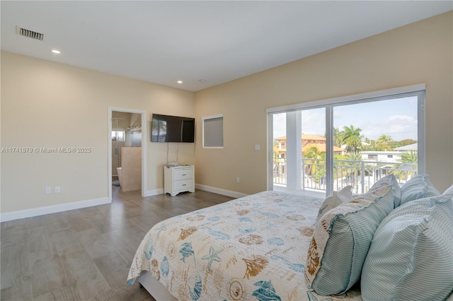 bedroom with hardwood / wood-style flooring and access to exterior