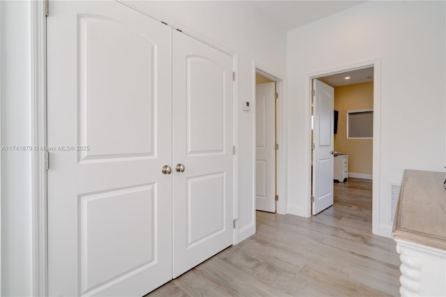 hallway with light hardwood / wood-style flooring