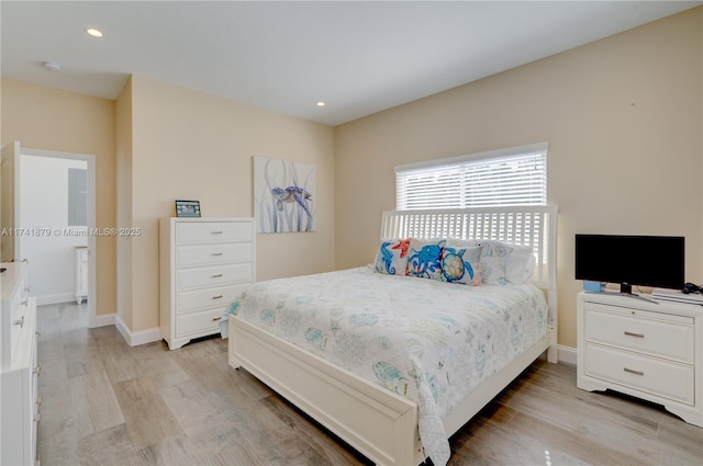 bedroom featuring radiator and light hardwood / wood-style floors