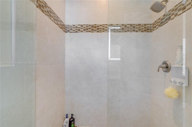 bathroom with tiled shower