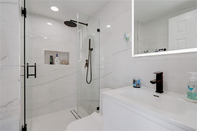 bathroom featuring walk in shower, toilet, sink, and tile walls