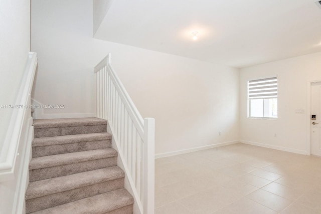 staircase featuring tile patterned floors