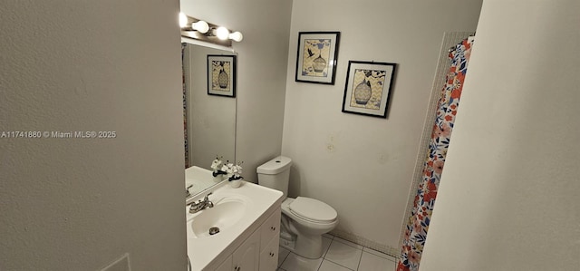 bathroom with vanity, tile patterned flooring, and toilet