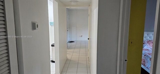 hall featuring light tile patterned floors