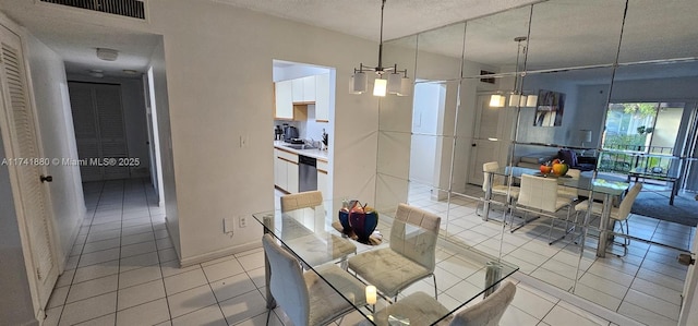 dining room featuring sink, a textured ceiling, and light tile patterned floors