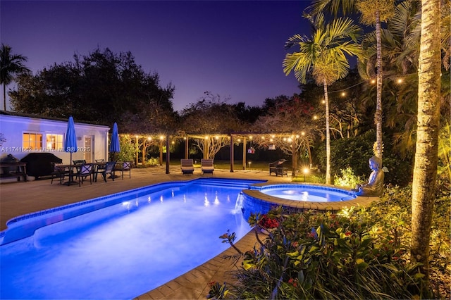 view of swimming pool with an in ground hot tub and a patio area