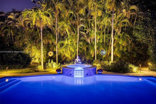 view of swimming pool featuring an in ground hot tub