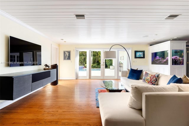 living room with crown molding, light hardwood / wood-style floors, french doors, and wooden ceiling