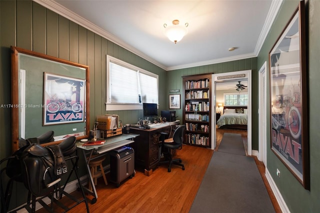 home office with hardwood / wood-style floors and crown molding