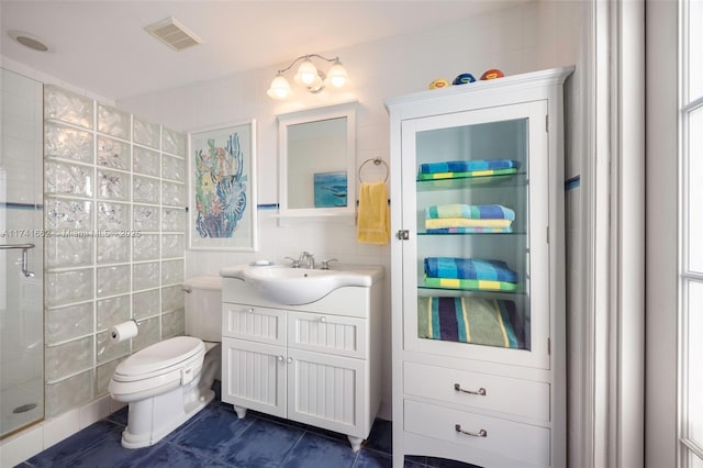 bathroom with vanity, tile walls, an enclosed shower, and toilet