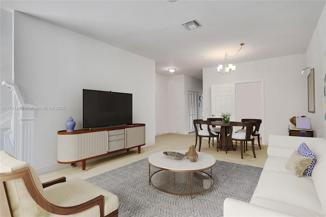 living room with an inviting chandelier, light tile patterned flooring, baseboards, and visible vents