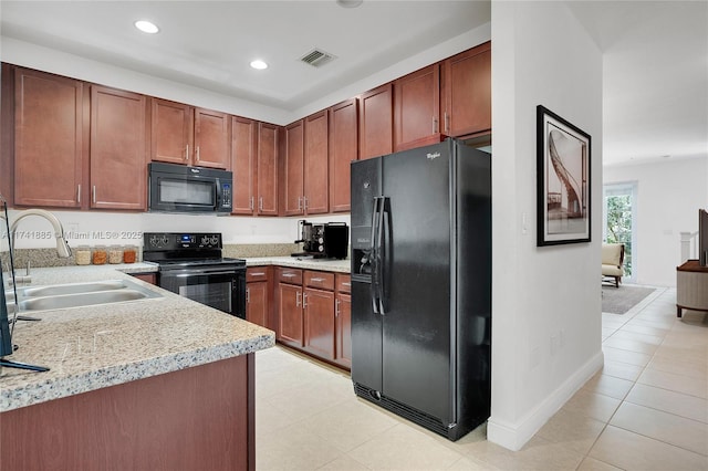 kitchen featuring visible vents, light countertops, recessed lighting, black appliances, and a sink