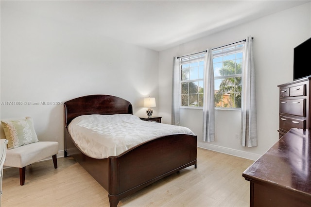 bedroom featuring baseboards and light wood-type flooring