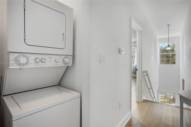 827 SW 147th Ave Unit 1406, Pembroke Pines, FL 33027 - laundry area featuring stacked washer / dryer, plenty of natural light, and wood finished floors