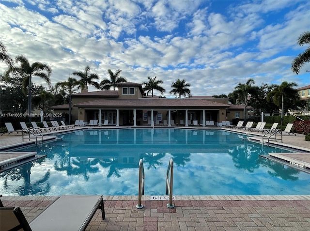 community pool featuring a patio area and fence