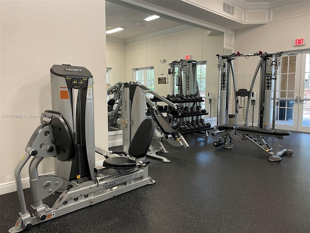 exercise room with baseboards and ornamental molding