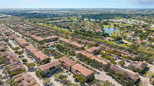 drone / aerial view featuring a residential view and a water view