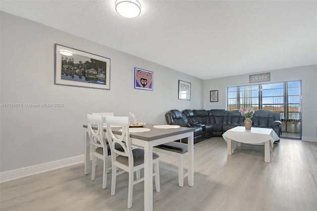 dining space featuring light wood-type flooring