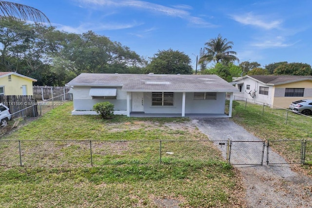 view of front of property with driveway, a fenced front yard, a gate, and a front yard