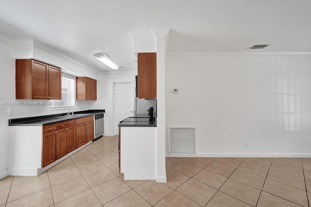 kitchen with dark countertops, visible vents, and brown cabinets