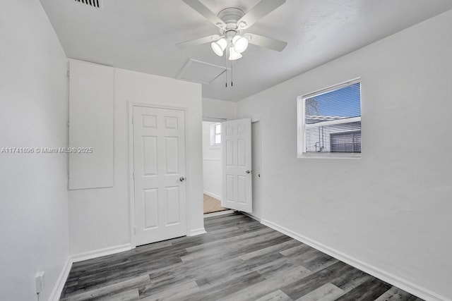 unfurnished room featuring a ceiling fan, baseboards, and wood finished floors