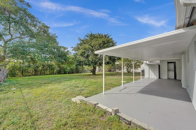 view of yard featuring a carport and fence