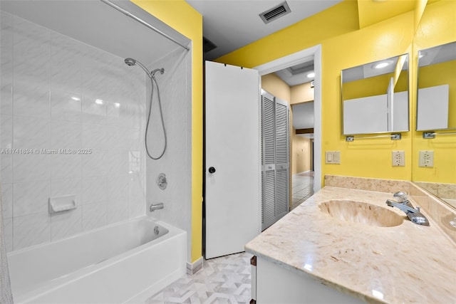 bathroom with vanity and tiled shower / bath combo